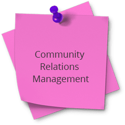 A pink post it note with the words community relations management on top.