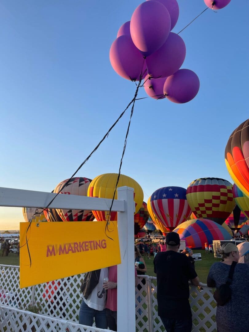 A bunch of balloons that are in the air